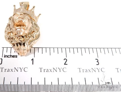 Small rose gold lion head pendant with crown and diamond accents, about 1 inch tall