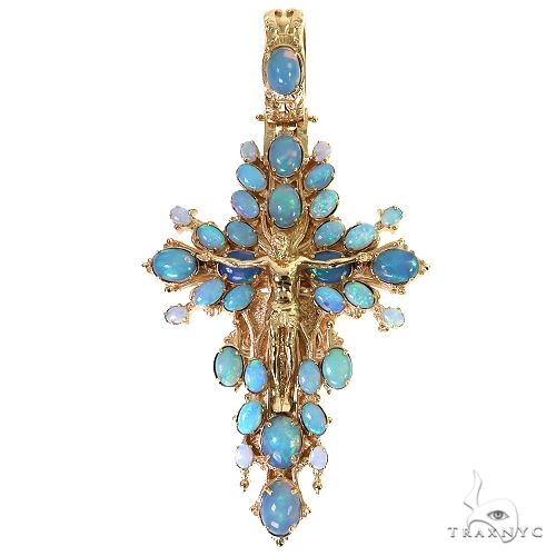 Yellow gold cross pendant with blue opal stones and detailed Jesus figure centerpiece