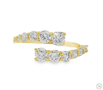 Yellow gold spiral ring with graduated round diamonds in a modern swirl design.