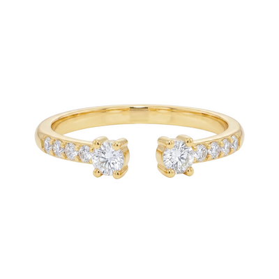 Yellow gold open ring with two central diamonds and smaller diamonds along the band.