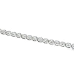 White gold bezel set tennis bracelet with round diamonds and secure clasp.