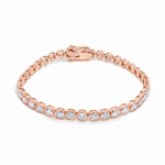 White gold bezel set tennis bracelet with round diamonds and secure clasp.