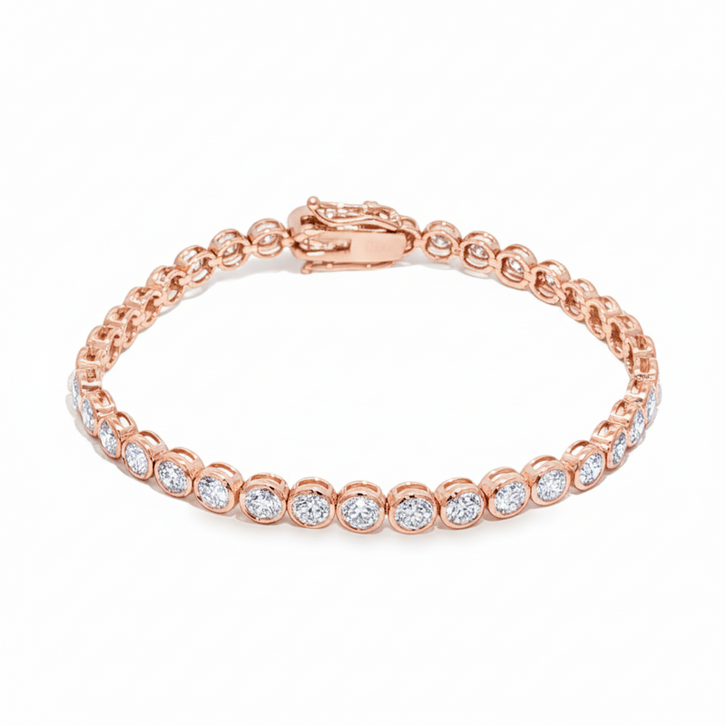 White gold bezel set tennis bracelet with round diamonds and secure clasp.