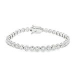 White gold bezel set tennis bracelet with round diamonds and secure clasp.