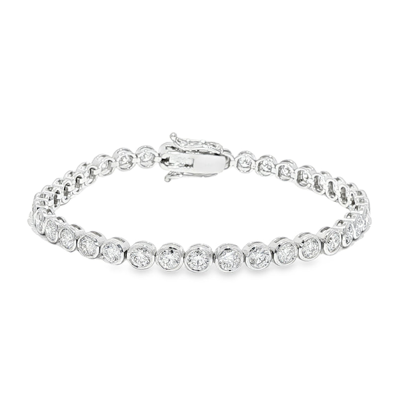 White gold bezel set tennis bracelet with round diamonds and secure clasp.