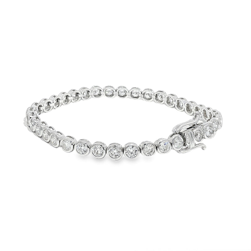 White gold bezel set tennis bracelet with round diamonds and secure clasp.