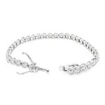 White gold bezel set tennis bracelet with round diamonds and secure clasp.