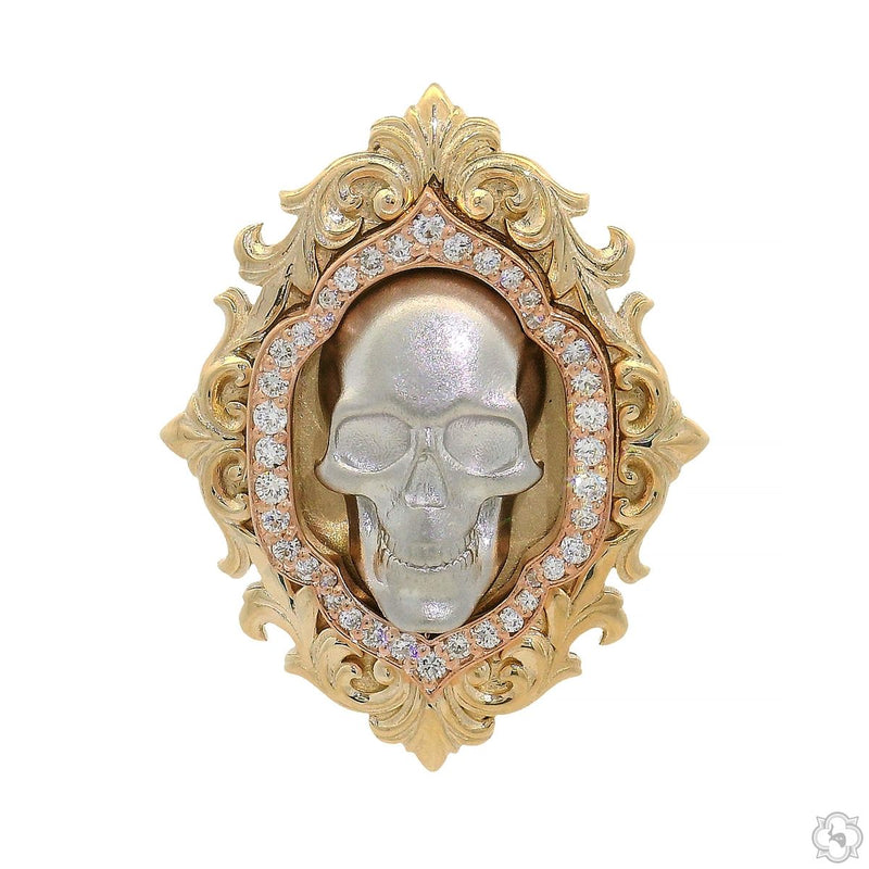 Baroque-style gold skull pendant with intricate detailing and rhinestone accents