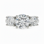 Sophia round three stone lab grown diamond engagement ring in 14K gold with a 2 carat round center diamond, two 0.70 carat round side stones, and a polished 2.00mm band.