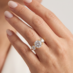 Sophia round three stone lab grown diamond engagement ring in 14K yellow gold with a 2 carat round center diamond, two 0.70 carat round side stones, and a polished 2.00mm band.