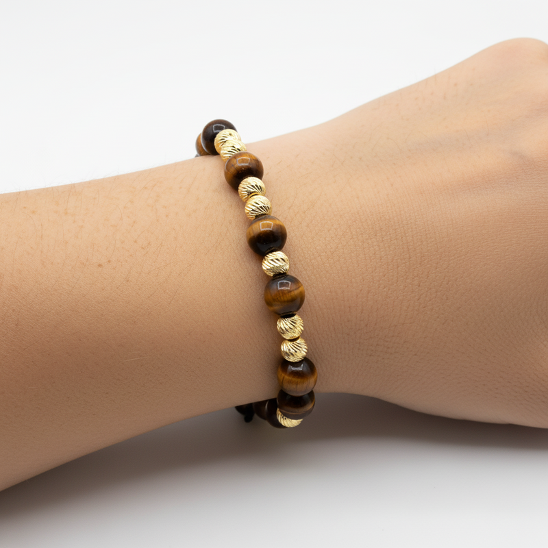 Adjustable men's bracelet with polished tiger eye and textured gold beads on black cord.