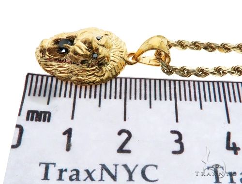 Yellow gold lion pendant with black diamond center on a twisted rope chain