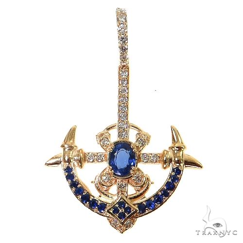 Yellow gold anchor pendant with blue gemstones and diamond accents on bail
