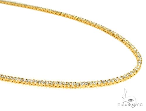 14K yellow gold diamond tennis chain with round prong-set stones, full-length flat lay view