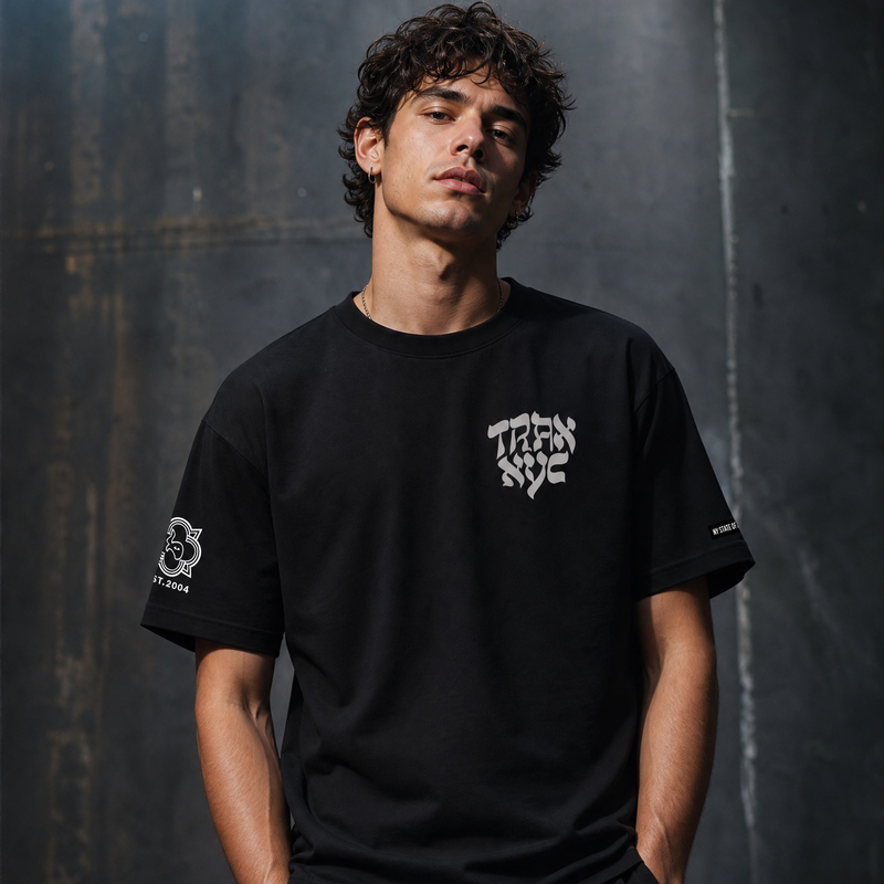 Person wearing a black t-shirt with white text and graphics against a dark textured background