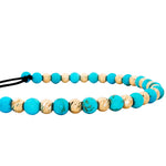 Turquoise and gold bead adjustable bracelet with black woven cord and sliding knot closure.