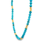 Turquoise bead necklace with textured gold spacer beads, vibrant blue and polished finish.