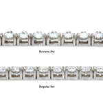 White gold tennis chain with round 75 pointer diamonds, sleek luxury men's jewelry.