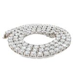 White gold tennis chain with round 75 pointer diamonds, sleek luxury men's jewelry.