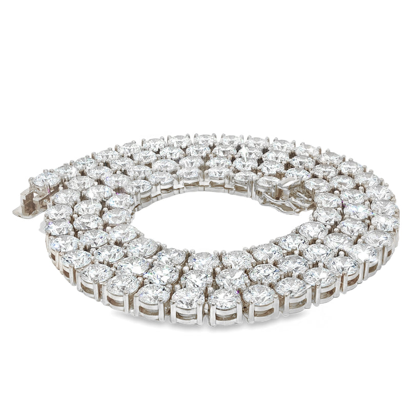 White gold tennis chain with round 75 pointer diamonds, sleek luxury men's jewelry.