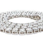 White gold tennis chain with round 75 pointer diamonds, sleek luxury men's jewelry.