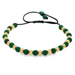 Adjustable bracelet with alternating green malachite and textured gold round beads on black cord.