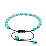 Turquoise and gold bead adjustable bracelet with black woven cord and sliding knot closure.