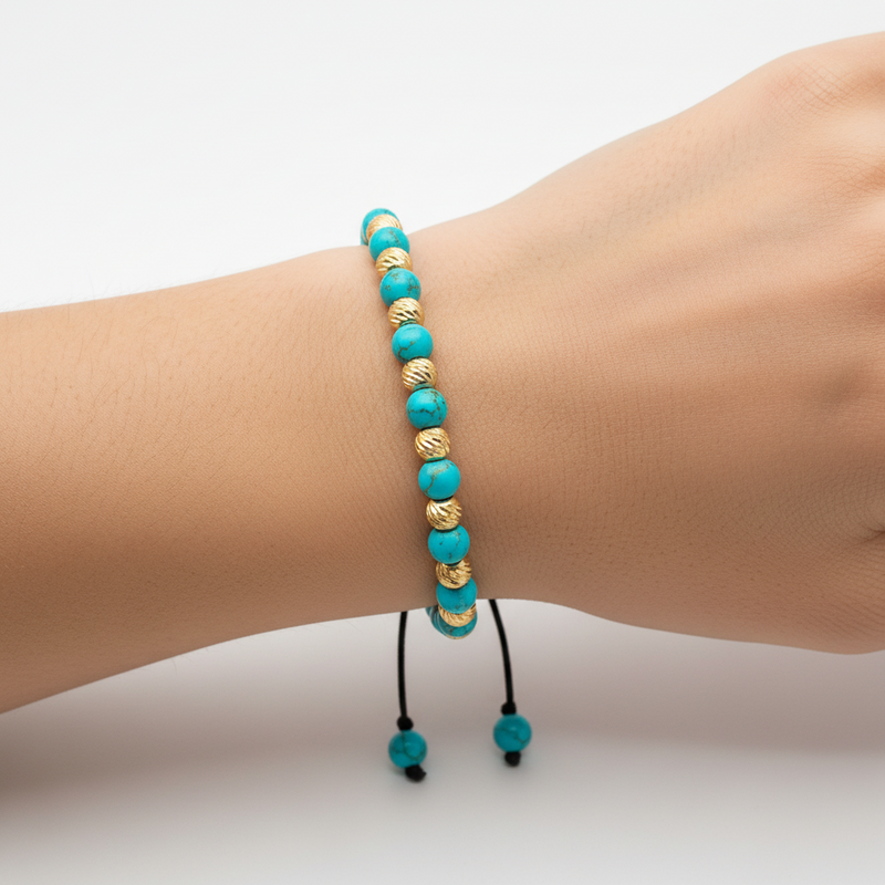 Turquoise and gold bead adjustable bracelet with black woven cord and sliding knot closure.