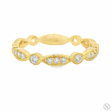 Yellow gold vintage-inspired diamond band with textured finish and round diamonds.