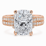 Rose gold engagement ring with large cushion-cut diamond and triple diamond halo band.