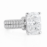 White gold engagement ring with large cushion-cut diamond and double pavé band.