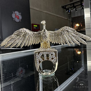Yellow gold diamond ring shaped like an eagle with outstretched wings and "KTB" initials.