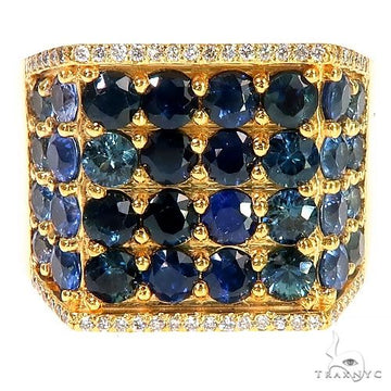 Wide yellow gold ring with multiple round blue sapphires and a diamond border.
