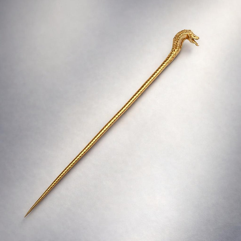 Sleek 24K gold stick pin with detailed cobra head design and textured body