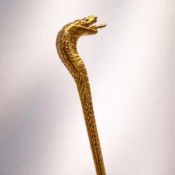 24K gold cobra snake sculpture with intricate scale details and a poised open mouth.
