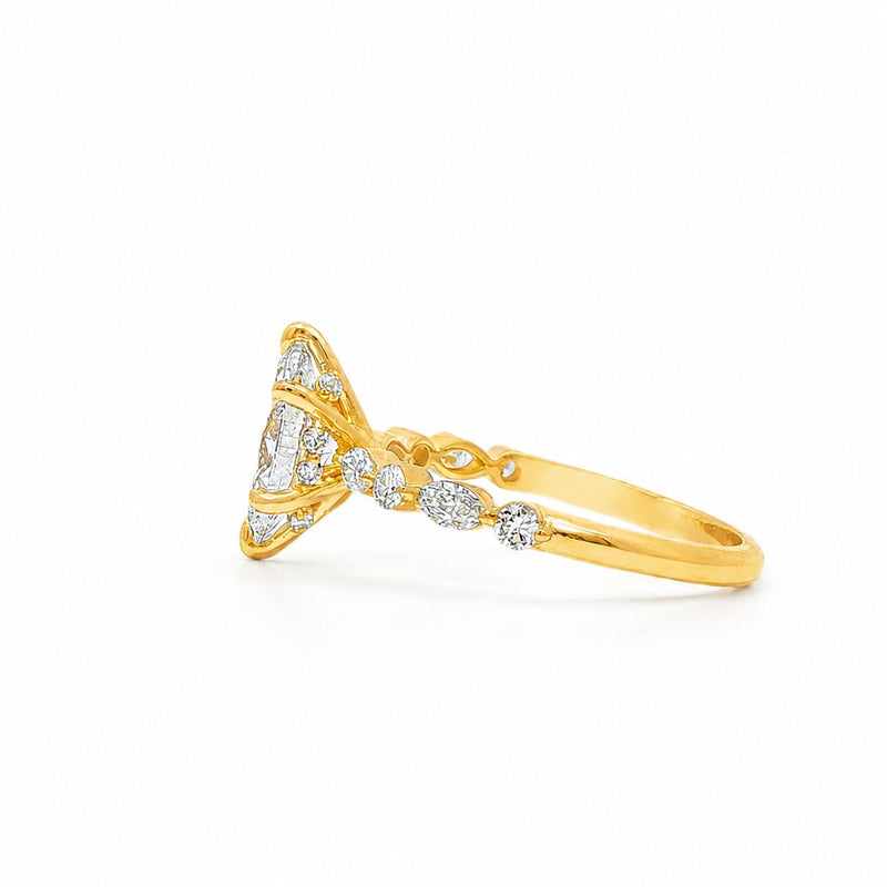Gold engagement ring with marquise diamond center and small round diamonds on band.