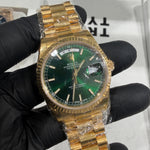 Rolex Day-Date 118238 in 18K yellow gold with a green sunburst dial, gold stick hour markers, and Chinese day display.