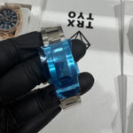 Baguette diamond-set bezel framing a diamond-covered dial with contrasting light blue chronograph counters.

