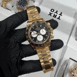 Rolex Cosmograph Daytona Le Mans 40mm reference 126525LN in solid 18K yellow gold with black dial and white ‘panda’ subdials, black ceramic tachymeter bezel, shown on matching yellow gold Oyster bracelet, pre-owned with light wear.