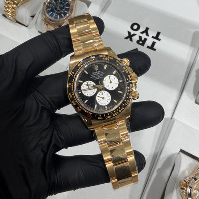 Rolex Cosmograph Daytona Le Mans 40mm reference 126525LN in solid 18K yellow gold with black dial and white ‘panda’ subdials, black ceramic tachymeter bezel, shown on matching yellow gold Oyster bracelet, pre-owned with light wear.