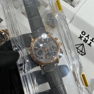 Patek Philippe 5004R Grand Complications 38mm in 18K rose gold with grey chronograph dial on grey crocodile strap, displayed in clear protective packaging