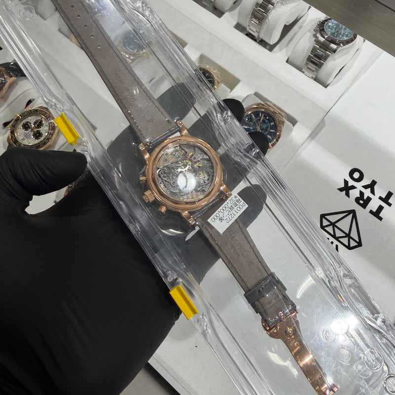 Close-up of Patek Philippe 5004R grey dial showing split-seconds chronograph, perpetual calendar subdials, and moonphase within a polished 18K rose gold case.