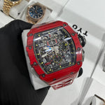 Richard Mille RM 11-03 in bright red NTPT carbon with a tonneau-shaped case and distinctive layered marbled pattern.

