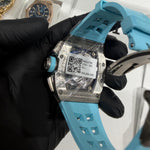 Richard Mille RM 11-01 on a light blue rubber strap, showcasing its bold colorway and football-inspired details.

