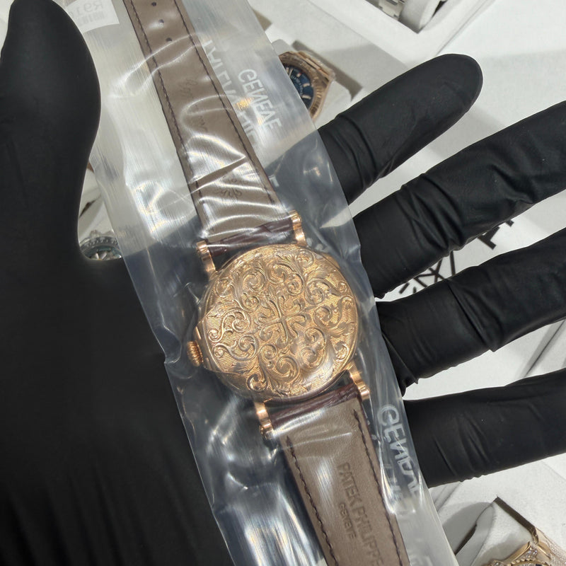 Hand-engraved rose gold caseback with detailed floral and arabesque patterns showcasing artisanal craftsmanship.

