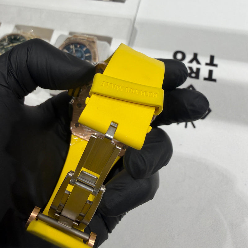 Richard Mille RM 11-03 yellow rubber strap with 18K rose gold deployment clasp buckle.