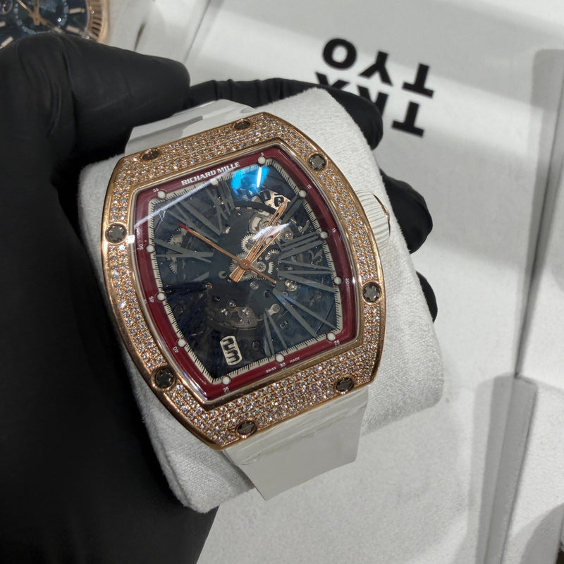 Richard Mille RM 023 in 18K rose gold with a full diamond pavé tonneau case and skeletonized dial.

