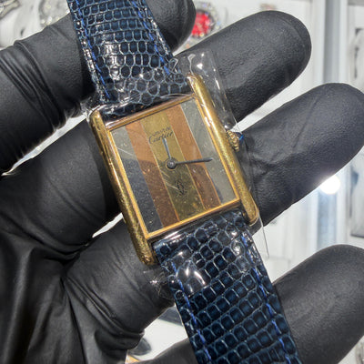 Cartier Must de Cartier Tank with a gold-plated rectangular case and tri-color striped dial in yellow, rose, and grey tones.

