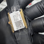 Cartier Must de Cartier Tank caseback with original price tag and QR code, held in black gloved hand
