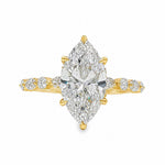 2.5 Ct marquise diamond engagement ring in yellow gold with accent diamonds on band.